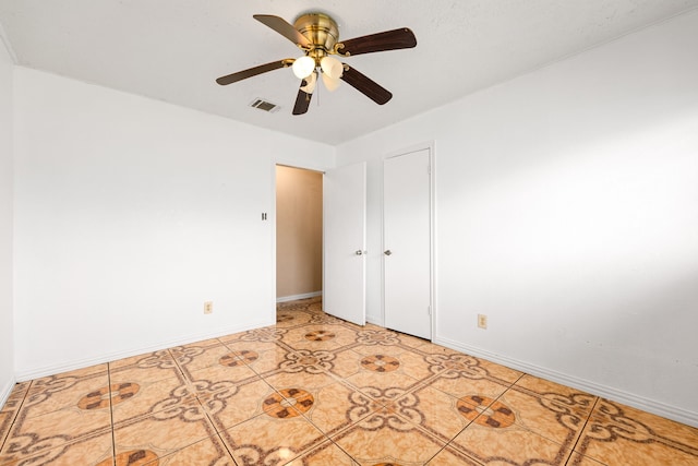 unfurnished room with light tile patterned floors, visible vents, and baseboards