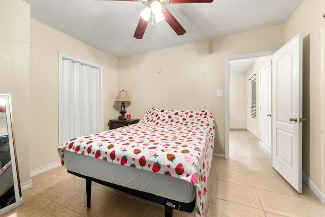 bedroom featuring ceiling fan, baseboards, and light tile patterned flooring