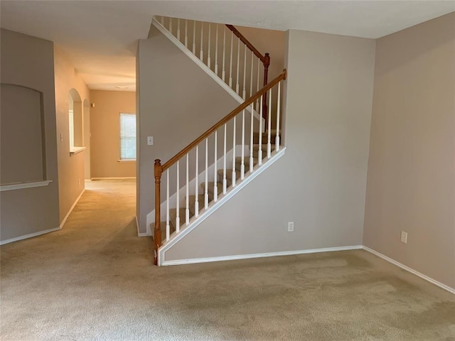 stairway with carpet and baseboards