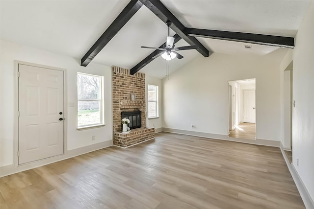 unfurnished living room featuring a ceiling fan, light wood-style floors, a brick fireplace, and baseboards