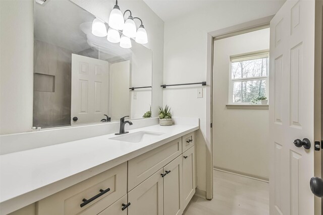 bathroom with a chandelier and vanity