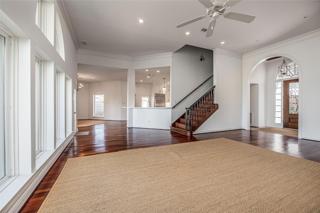 interior space featuring a healthy amount of sunlight, stairs, and dark wood-type flooring