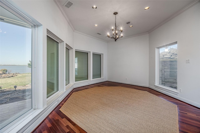 unfurnished sunroom featuring a chandelier, a water view, and visible vents