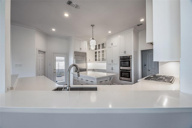 kitchen featuring glass insert cabinets, visible vents, stainless steel appliances, and a sink