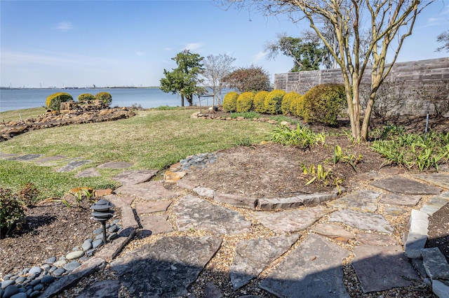 view of yard featuring a water view and fence