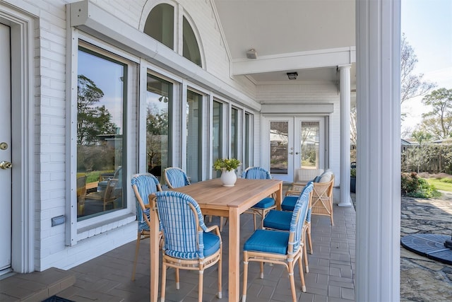 sunroom / solarium featuring french doors