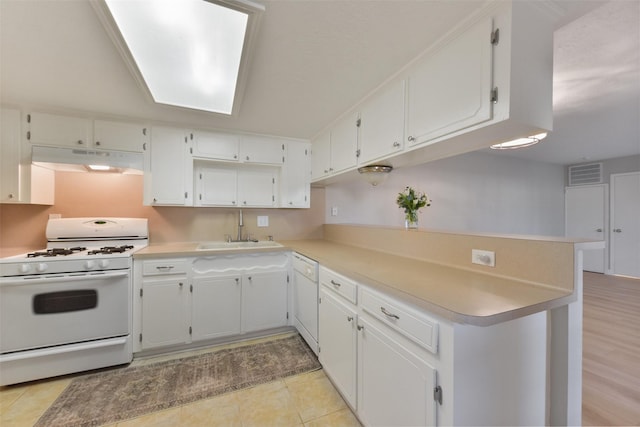 kitchen with white appliances, visible vents, a sink, white cabinets, and under cabinet range hood