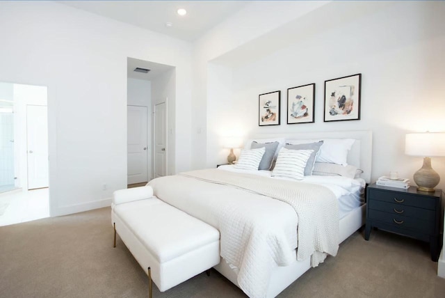 carpeted bedroom featuring baseboards and visible vents