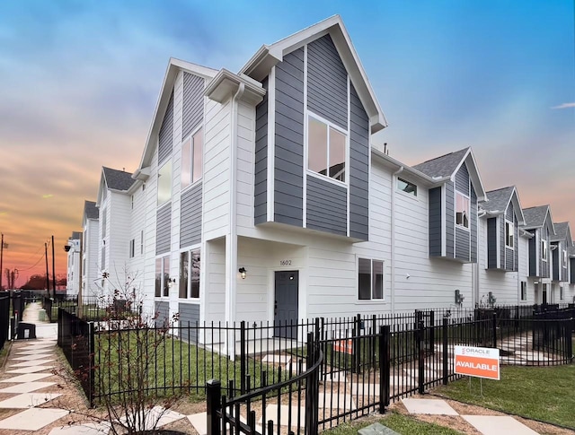 view of front of house featuring a fenced front yard and a residential view