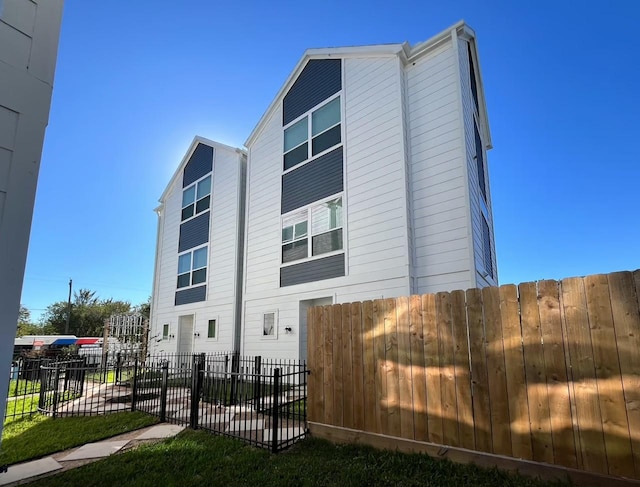 view of side of property featuring fence