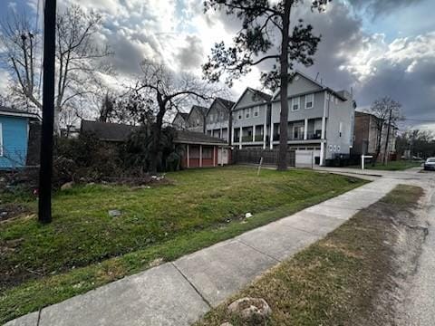 exterior space featuring a yard and a residential view