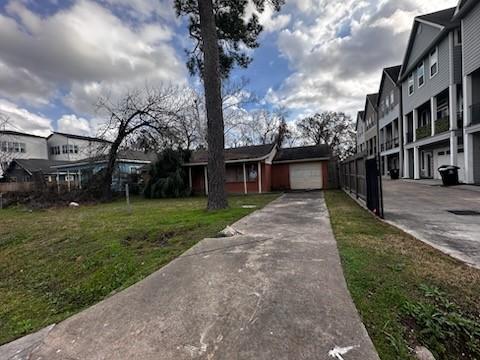 exterior space featuring a garage, driveway, and a front yard