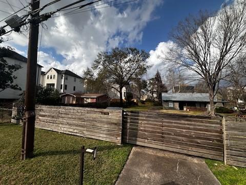 exterior space with a fenced front yard and a gate