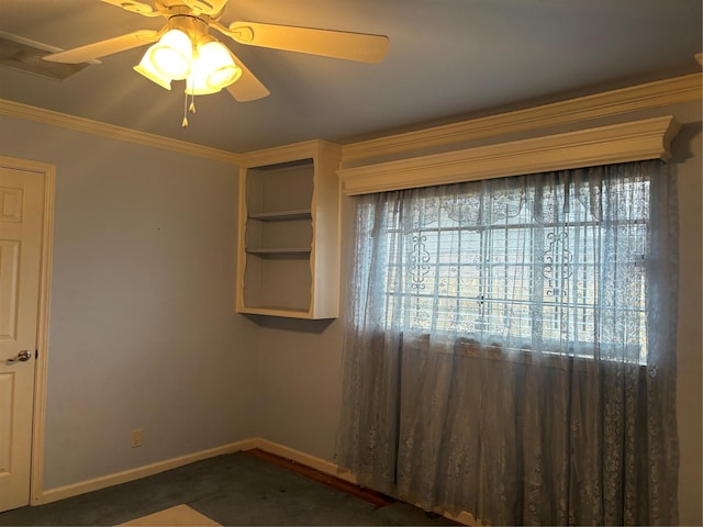 spare room featuring baseboards, ceiling fan, and crown molding