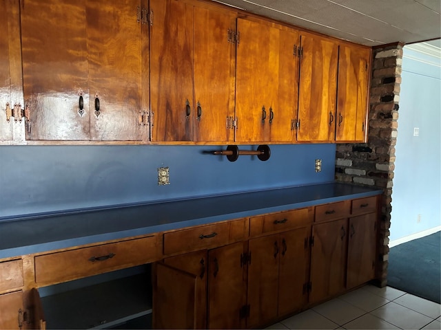 kitchen with brown cabinets and light tile patterned flooring