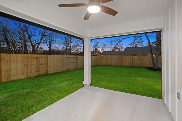 view of yard with a ceiling fan, a fenced backyard, and a patio