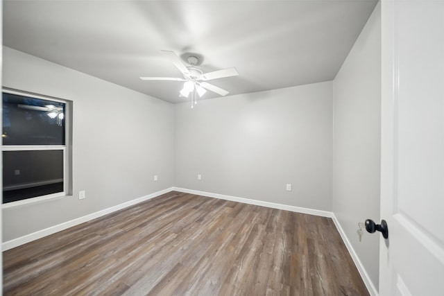 empty room featuring ceiling fan, wood finished floors, and baseboards