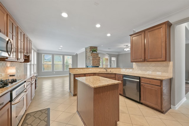 kitchen featuring light tile patterned floors, light stone counters, stainless steel appliances, a peninsula, and crown molding