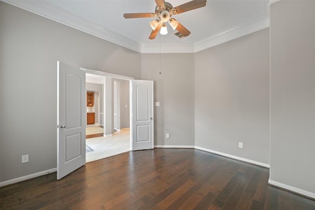 unfurnished room featuring crown molding, visible vents, baseboards, and wood finished floors