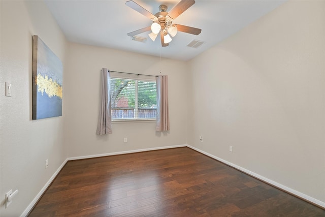 spare room with a ceiling fan, baseboards, visible vents, and wood finished floors