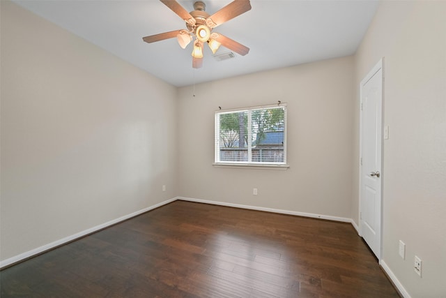 empty room featuring a ceiling fan, visible vents, baseboards, and wood finished floors