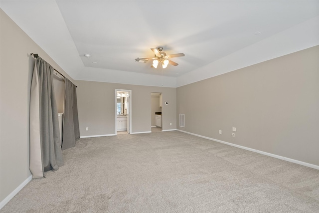 spare room featuring visible vents, ceiling fan, light carpet, and baseboards