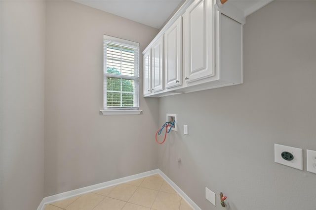 clothes washing area with cabinet space, baseboards, hookup for a gas dryer, washer hookup, and electric dryer hookup