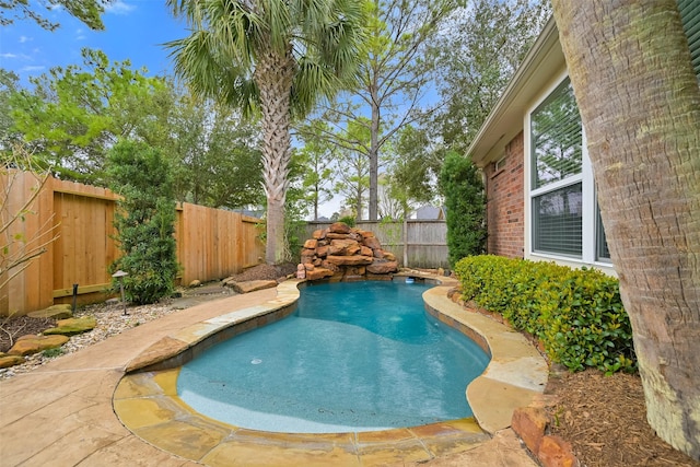 view of swimming pool with a fenced backyard and a fenced in pool