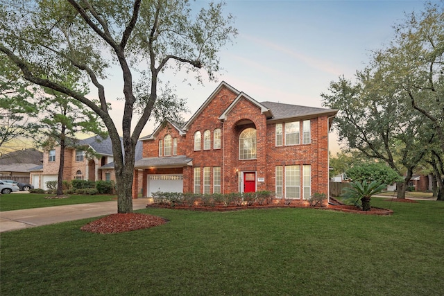 view of front of home with a front lawn, concrete driveway, brick siding, and an attached garage