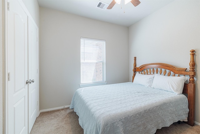 bedroom with baseboards, carpet, visible vents, and a ceiling fan