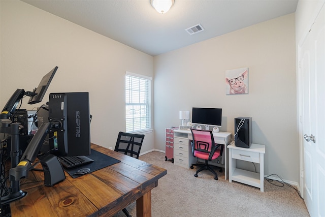 home office with light colored carpet, visible vents, and baseboards