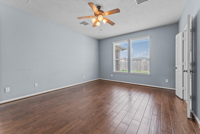 unfurnished bedroom with a textured ceiling, ceiling fan, dark wood-style flooring, visible vents, and baseboards