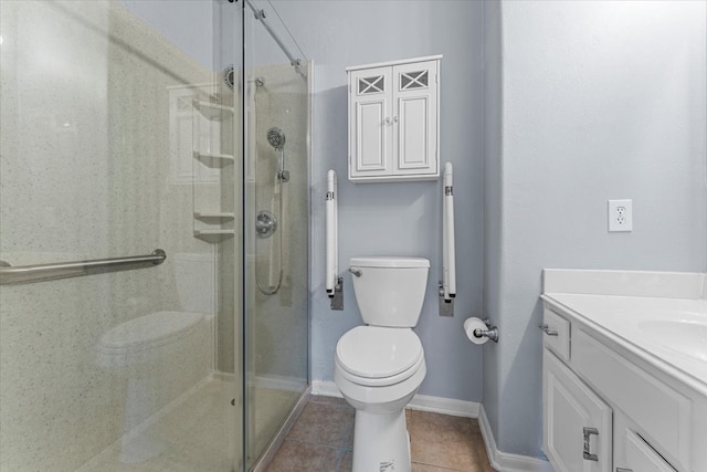 bathroom featuring toilet, vanity, a shower stall, baseboards, and tile patterned floors