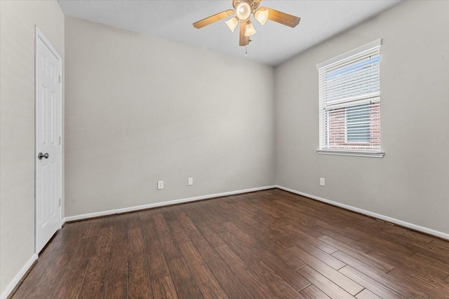 empty room featuring wood finished floors, a ceiling fan, and baseboards