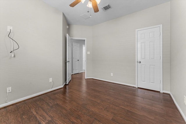 unfurnished room with a ceiling fan, baseboards, visible vents, and dark wood-type flooring