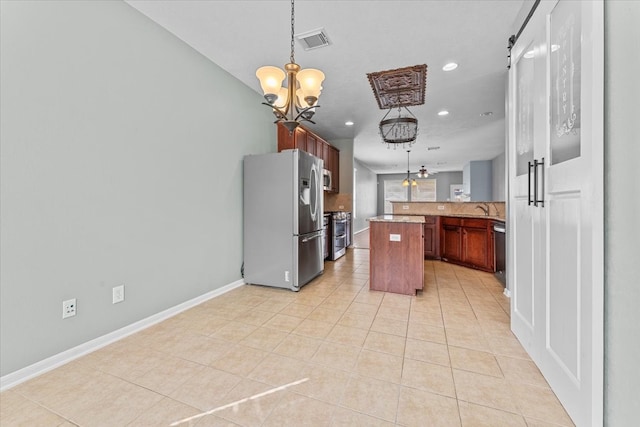 kitchen with a chandelier, appliances with stainless steel finishes, light tile patterned floors, and visible vents