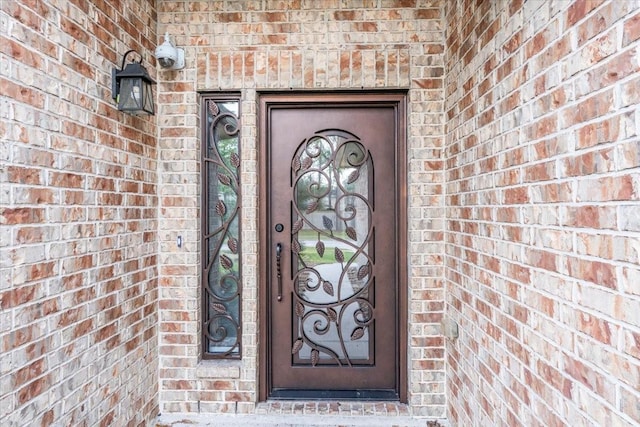 property entrance with brick siding