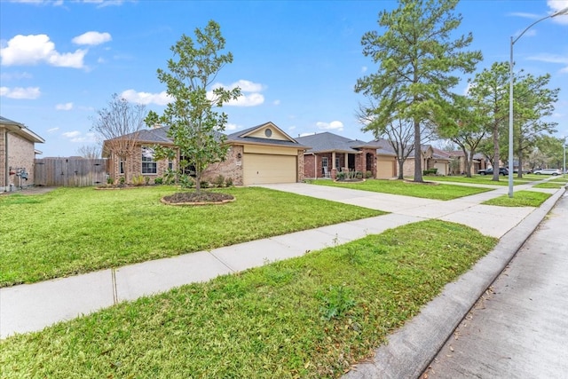 single story home with a garage, brick siding, fence, concrete driveway, and a front yard