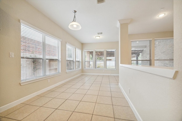 interior space featuring light tile patterned floors, visible vents, and baseboards