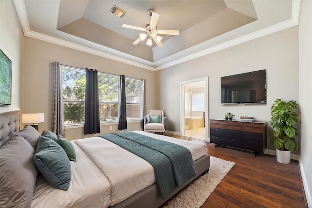 bedroom with dark wood-style floors, a raised ceiling, visible vents, and baseboards