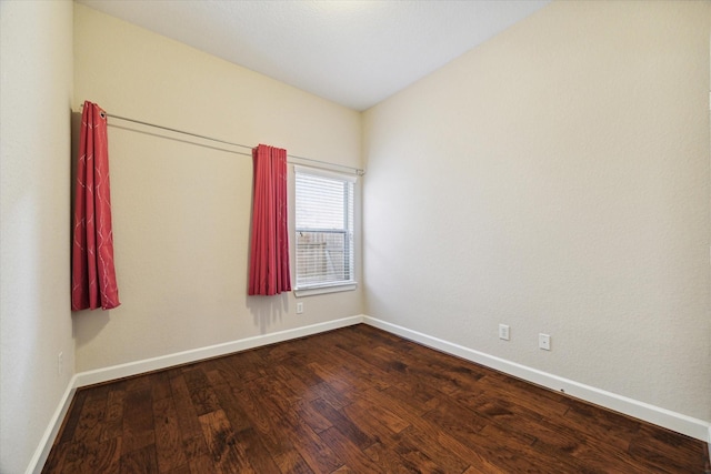 unfurnished room featuring baseboards and wood finished floors