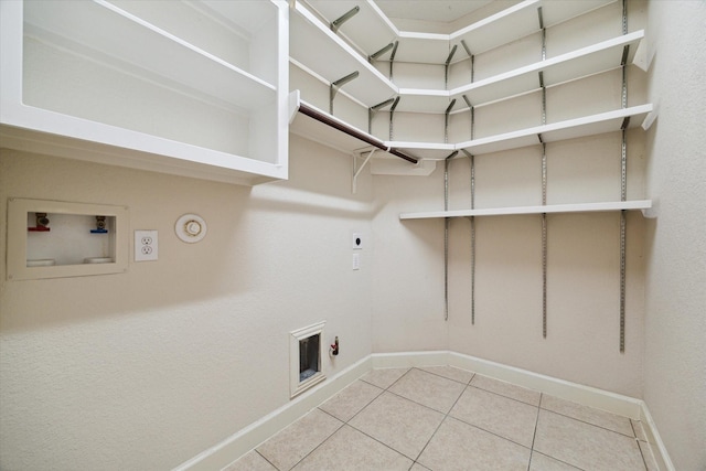 laundry room with laundry area, baseboards, gas dryer hookup, hookup for a washing machine, and hookup for an electric dryer