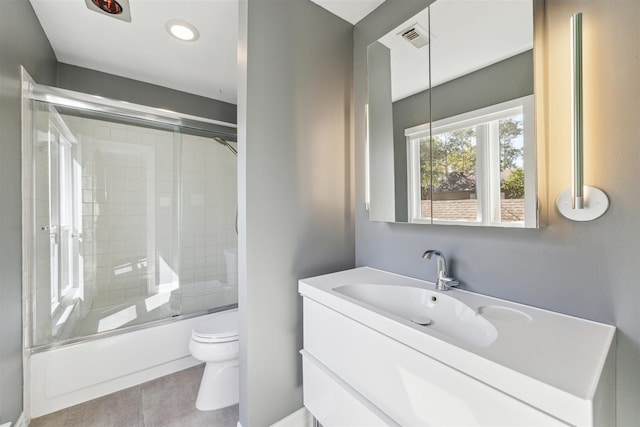 full bathroom featuring visible vents, toilet, tile patterned floors, combined bath / shower with glass door, and vanity