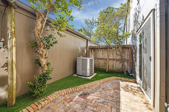 view of patio / terrace featuring cooling unit and fence