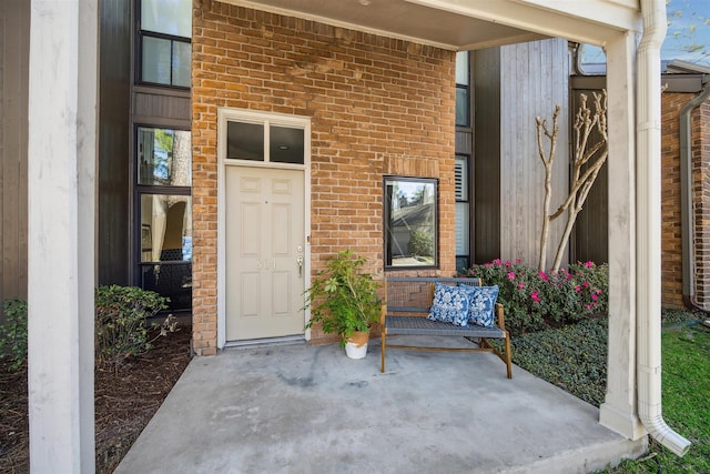 entrance to property with brick siding