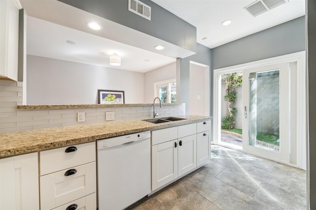 kitchen with a sink, visible vents, white cabinets, dishwasher, and tasteful backsplash