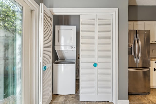 laundry area with stacked washer and dryer and laundry area