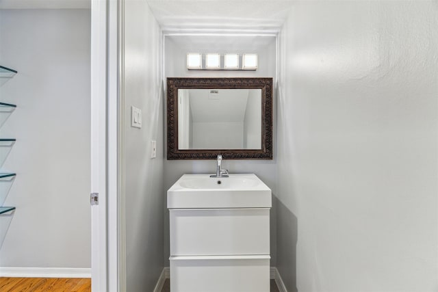 bathroom with vanity and baseboards