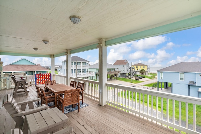 deck with a residential view and outdoor dining space