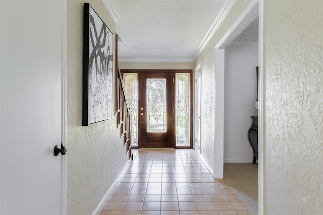 foyer featuring baseboards, a textured wall, stairway, ornamental molding, and light tile patterned flooring